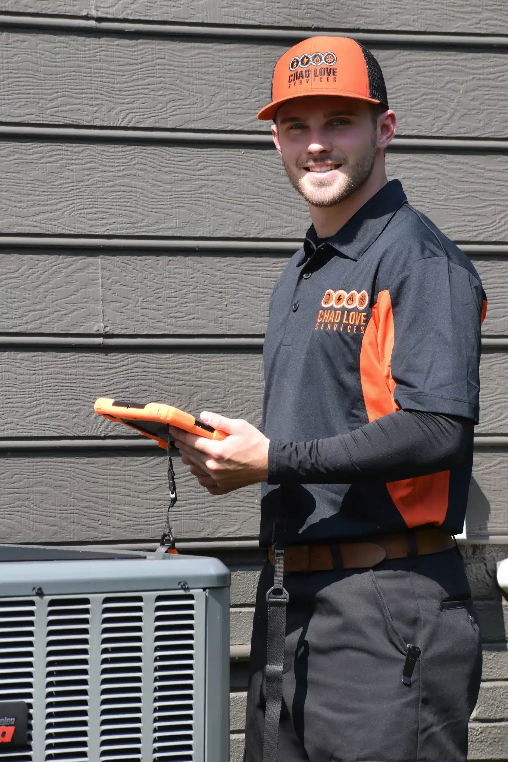Chad Love Services technician doing an AC tune up outside of a residential home in Davidson, NC