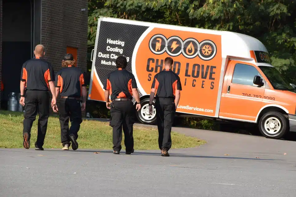 Chad Love Services Technicians walking towards work truck in Pineville, NC