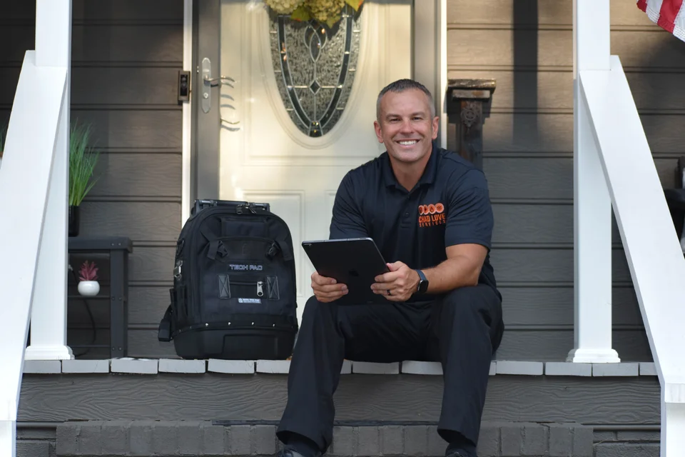 Chad of Chad Love Services sitting outside of a Charlotte home smiling