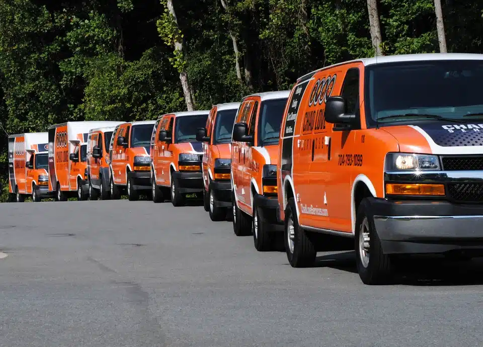 Chad Love Services trucks lined up on a residential street in Davidson, NC
