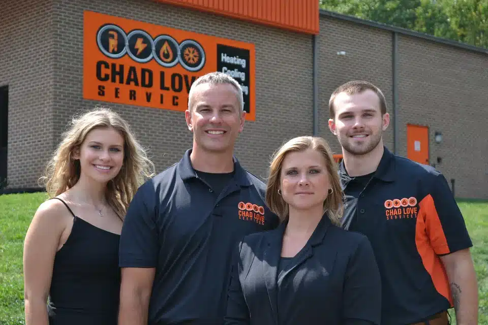 Chad Love Services Family standing in front of their office